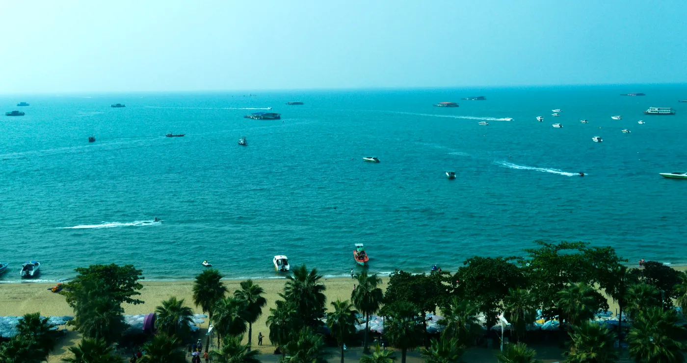 Palm-lined Pattaya Beach Road and the bay from above