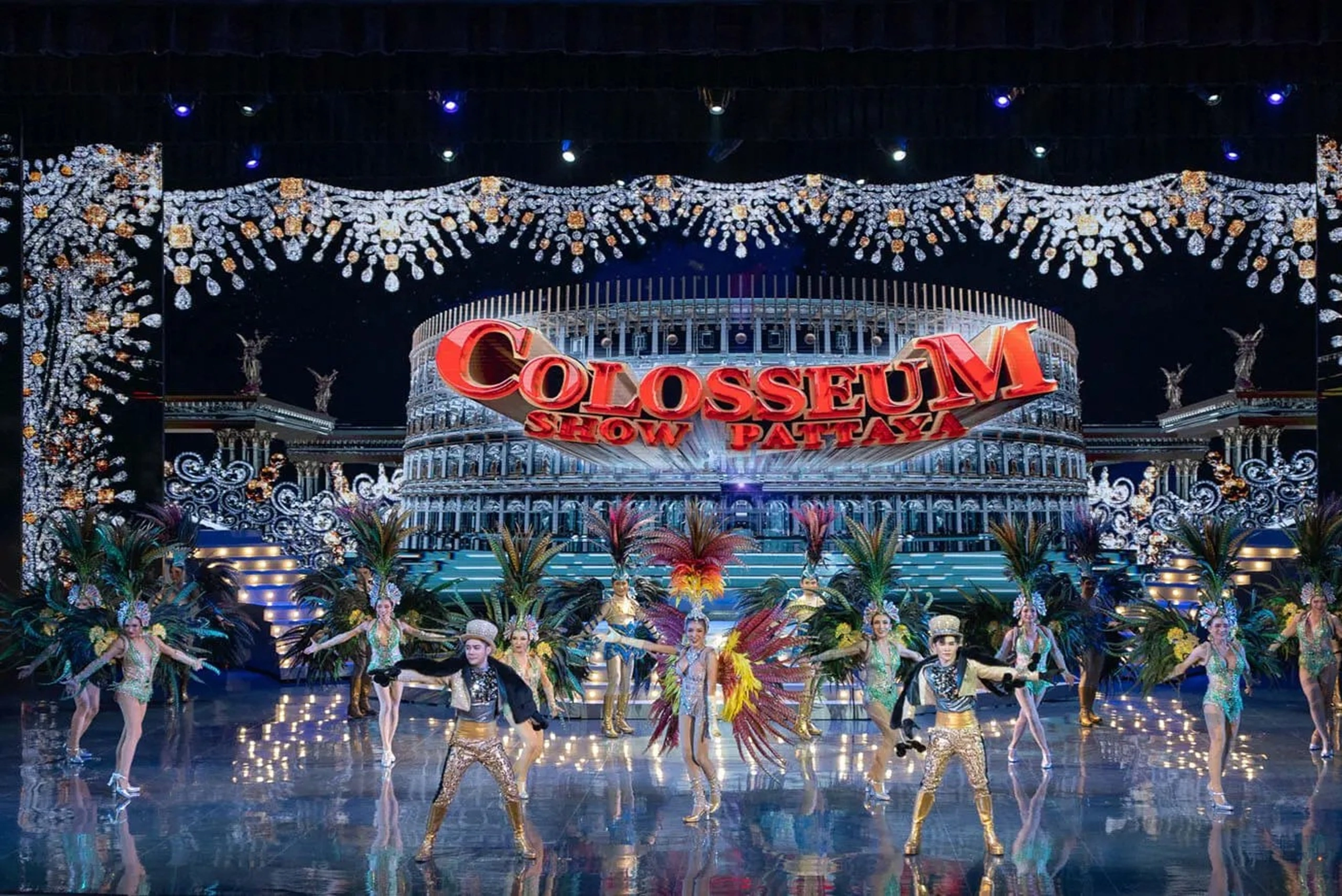 Performers in elaborate costumes on stage at the Colosseum Show Pattaya