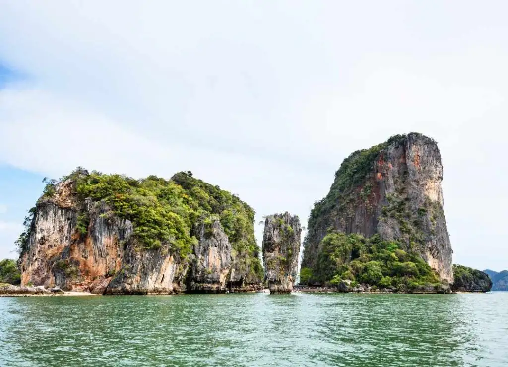 Limestone islands rising from the green water of Phang Nga Bay