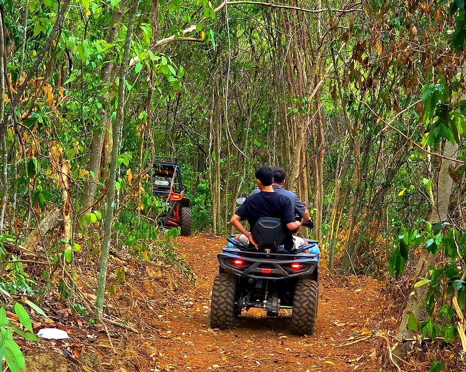 Riders on an ATV following the jungle trail near Pattaya
