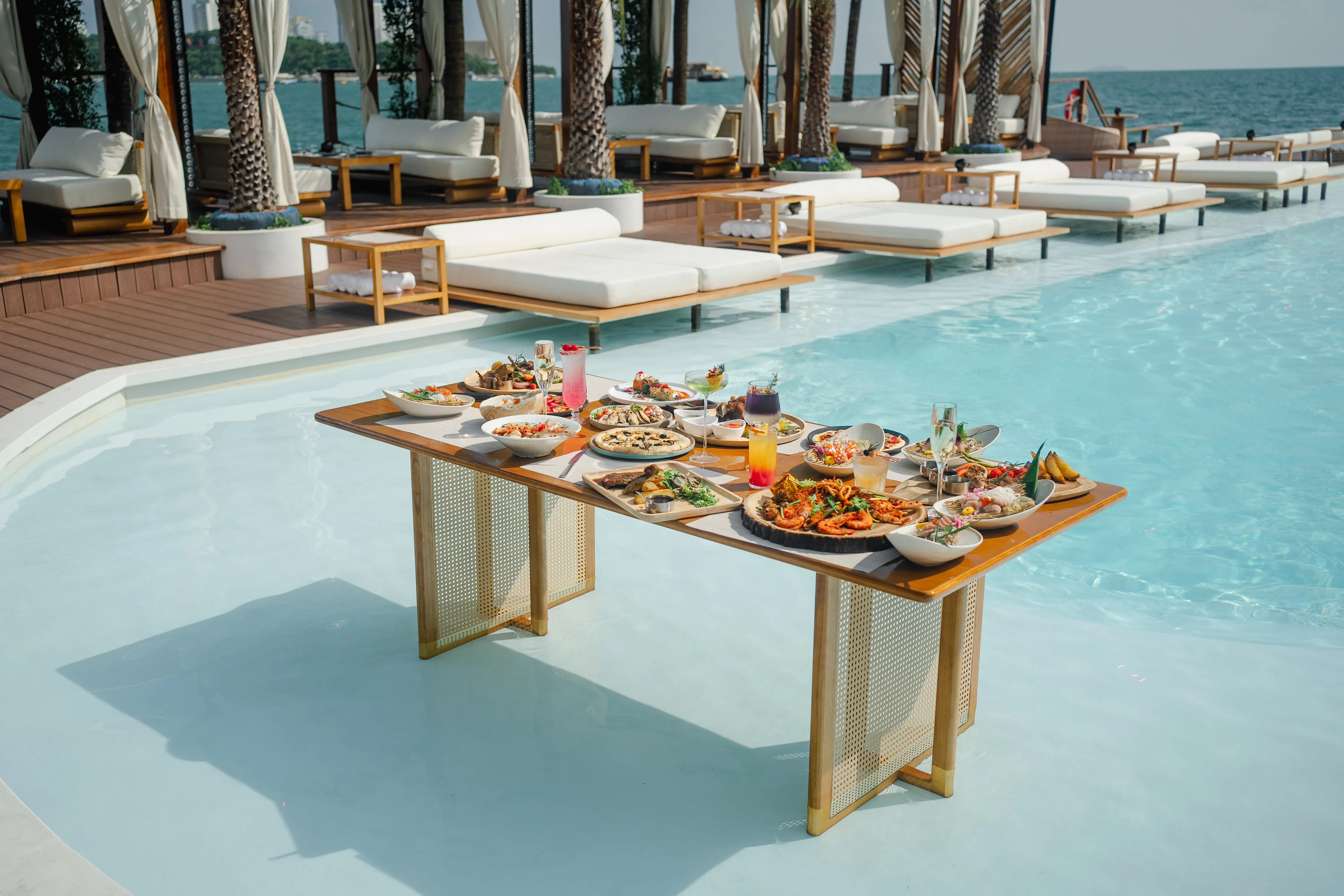 Private cabanas and loungers on the deck at Sina Beach Club Pattaya