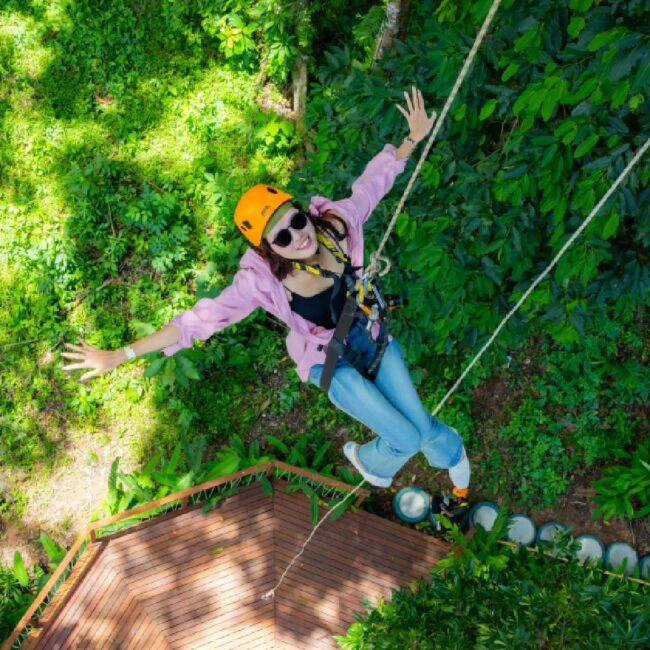 Guest ziplining over the rainforest at Sky Rock