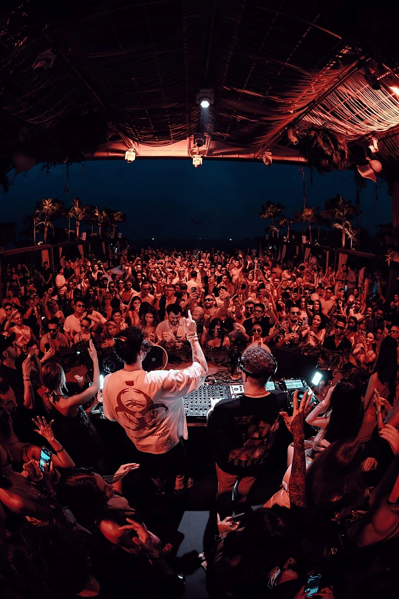 Night party at YONA Beach Club — DJ and a packed crowd under the canopy
